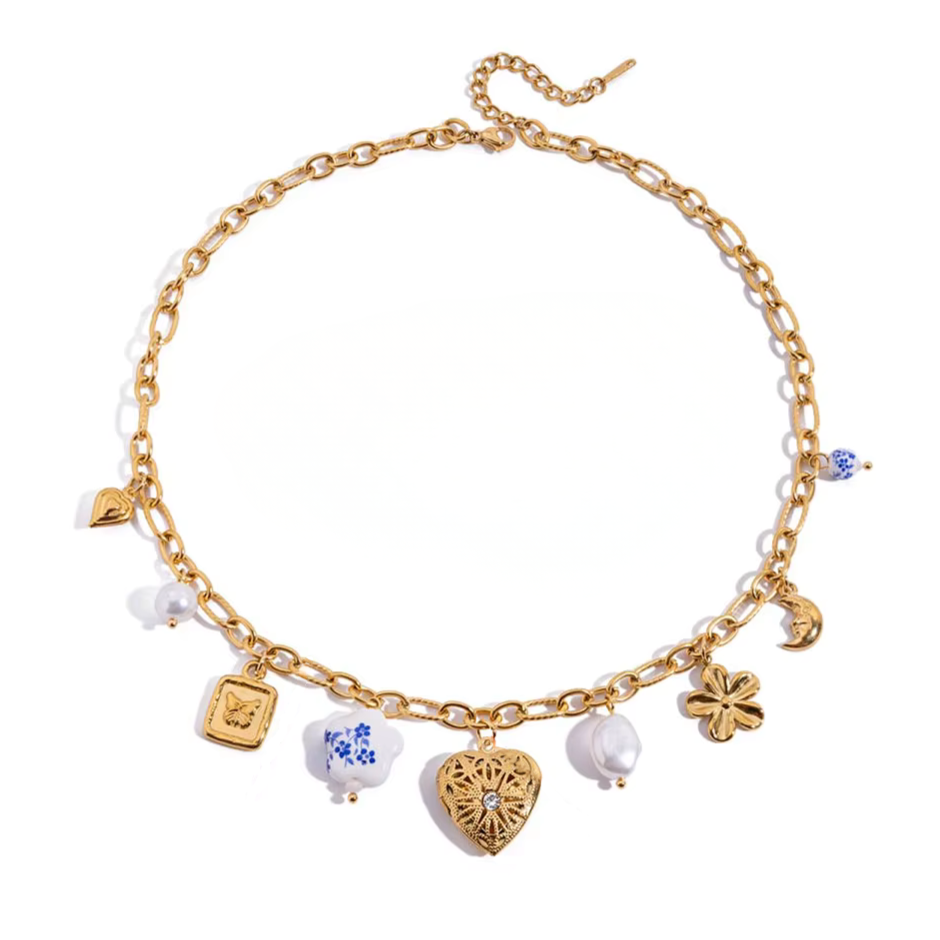 Fiore di Limone necklace by Calvéra with gold charms inspired by flowers, pearls, hearts and butterflies