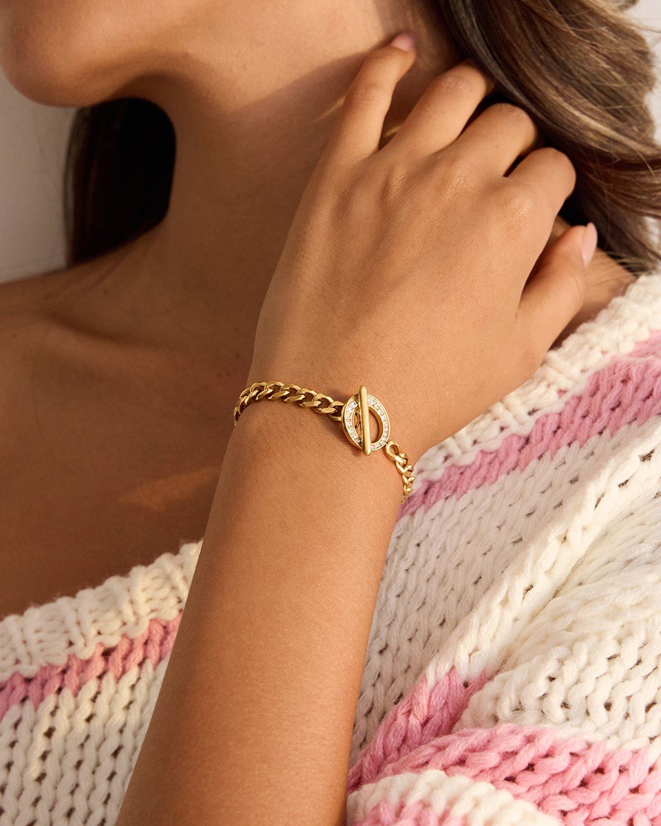 Anello di Luce Bracelet worn on wrist with gold chain and crystal charm