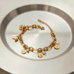 An elegant 'Ancient Charm' gold bracelet, merging refined Eastern taste with enduring Italian PVD gold quality.