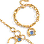 Arco Azzurro Bracelet two gold bracelets flat lay with blue stone accents