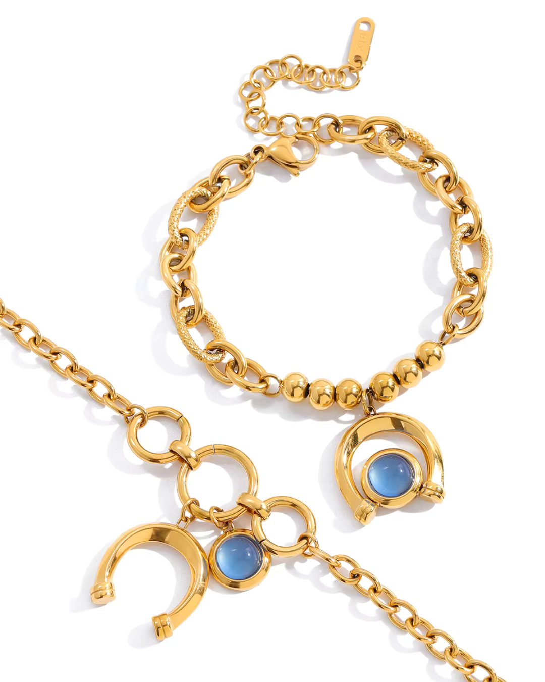 Arco Azzurro Bracelet two gold bracelets flat lay with blue stone accents