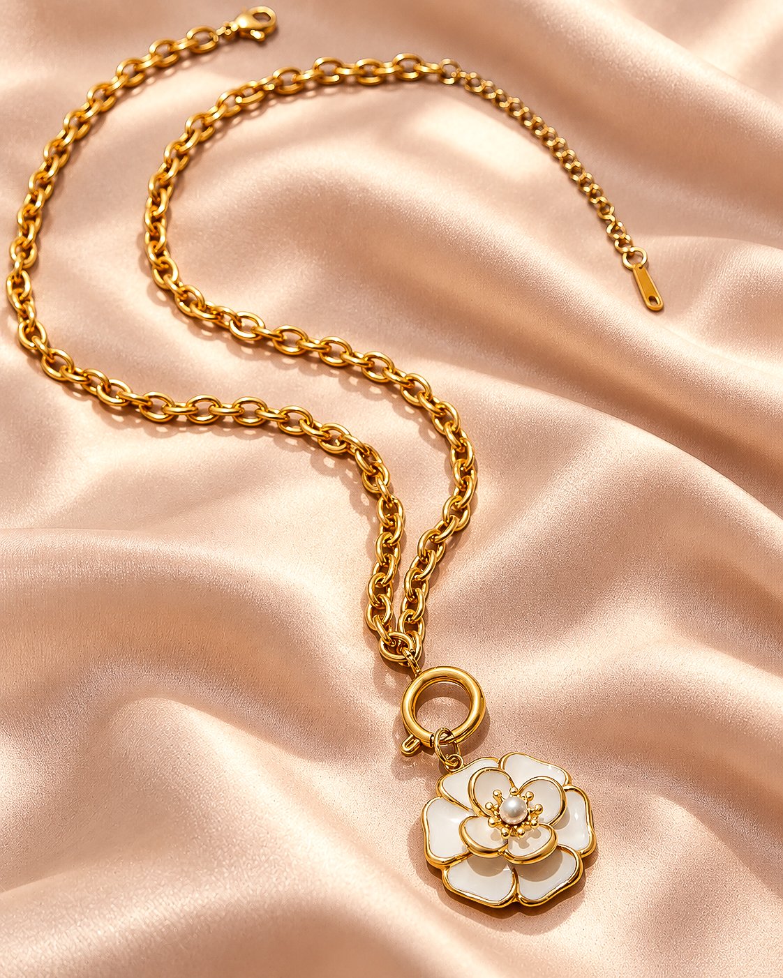 Flat lay of Avelora Necklace showing its elegant gold and silver-toned ring pattern on a neutral background