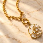 Close-up detail of Avelora Necklace showing polished golden rings and engraved silver-toned rings