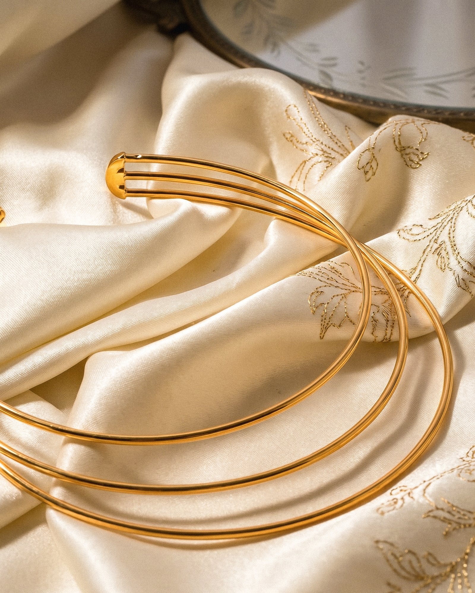 Collare Aureo Choker on background in angled view showing layered gold collar structure