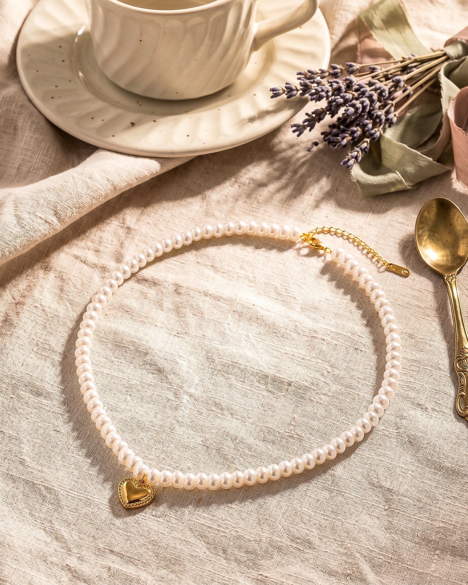 Cuore di Perla Necklace detail showing pearl-inspired beads and polished heart pendant