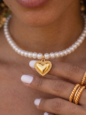 Close-up of Cuore di Perla Necklace on model showing pearl-inspired beads and heart pendant