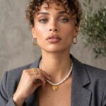 Cuore di Perla Necklace worn by model with pearl-inspired beads and gold heart pendant