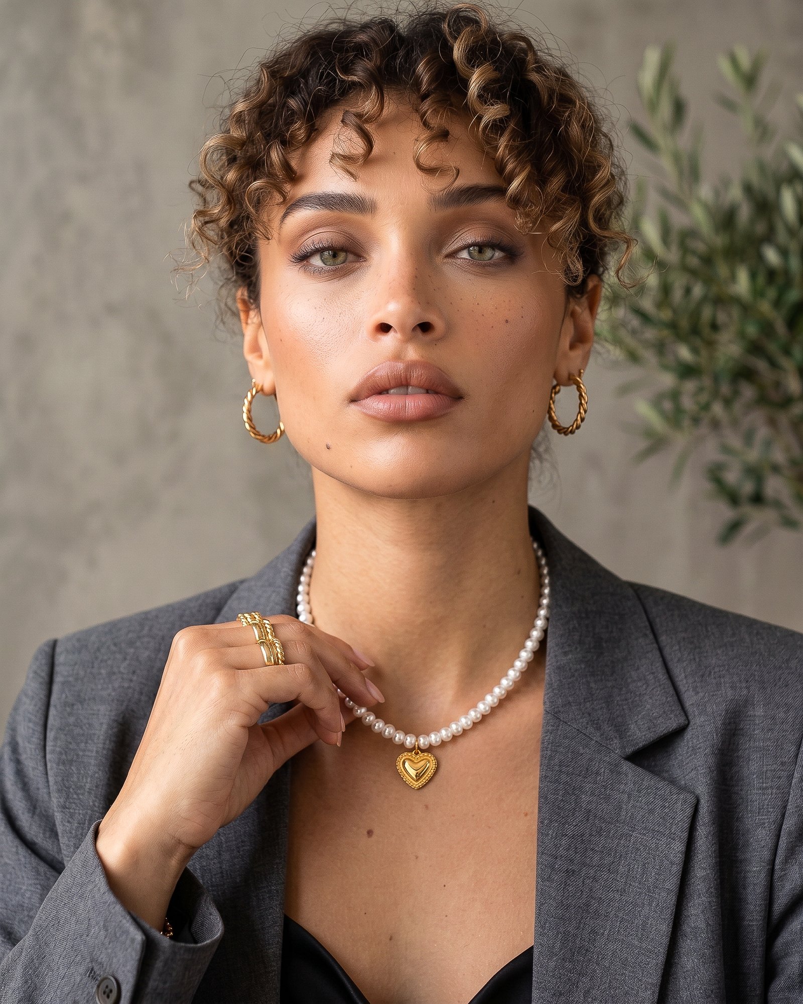Cuore di Perla Necklace worn by model with pearl-inspired beads and gold heart pendant