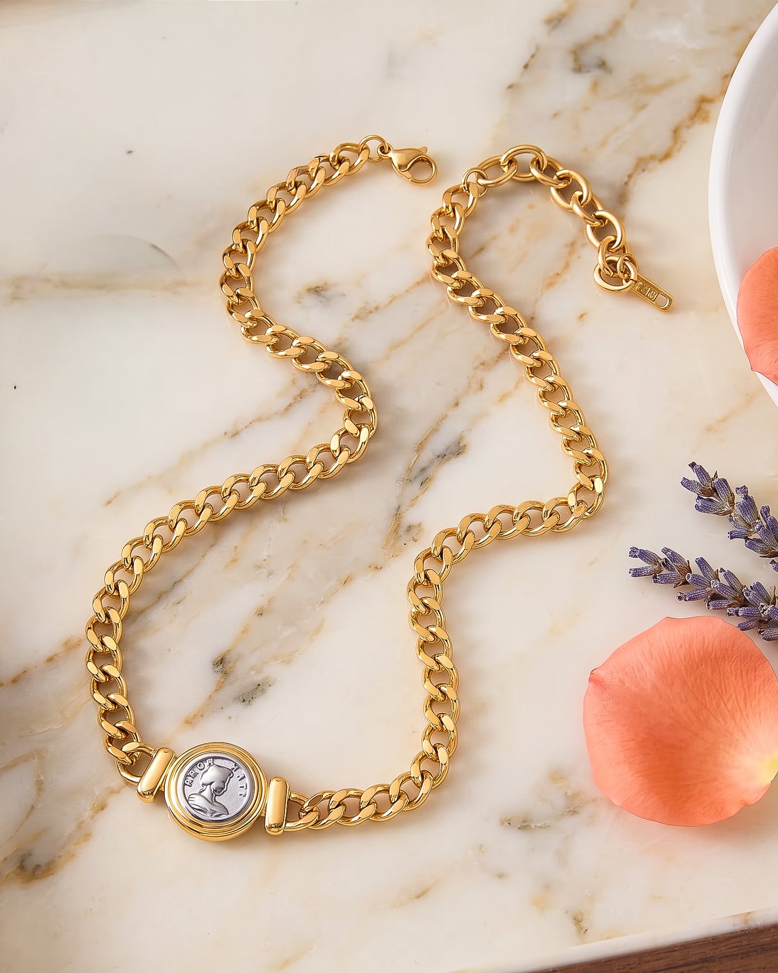 Eterna Eleganza Necklace on marble background with polished gold necklace design