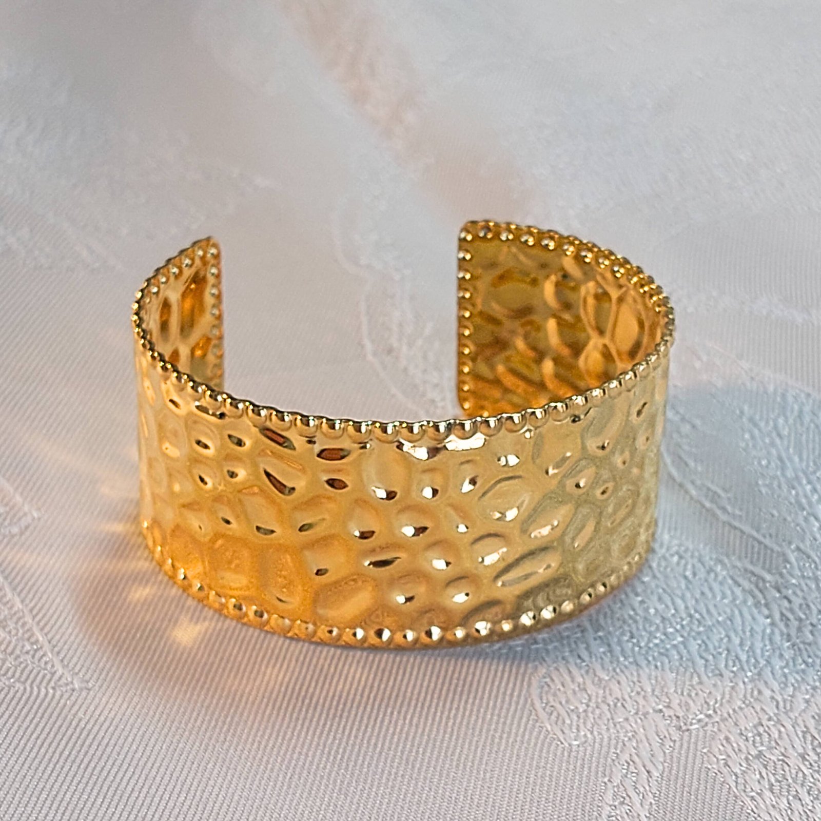 A luxurious 'Golden Weave' Cuff bracelet, merging high-end elegance with durable, water-resistant 18K PVD gold.