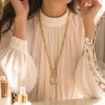 Valdora Necklace worn long on model with a refined side-angle view
