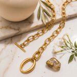 Valdora Necklace clasp and link detail on a marble background