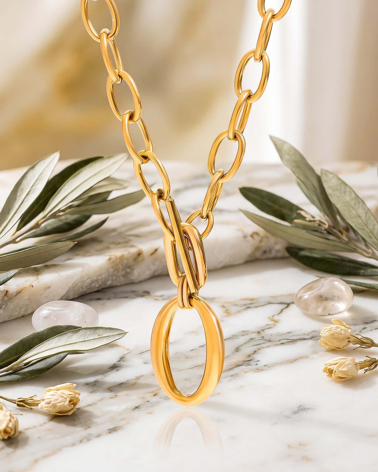 Close-up of Valdora Necklace chain links on a marble background