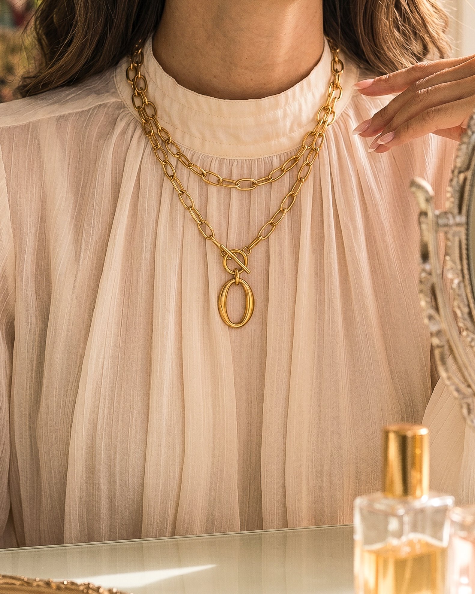 Valdora Necklace wrapped twice on model with a bold layered gold look