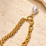 Valeria Necklace detail shot showing interlinked chain, open rings, and pearl-inspired pendant