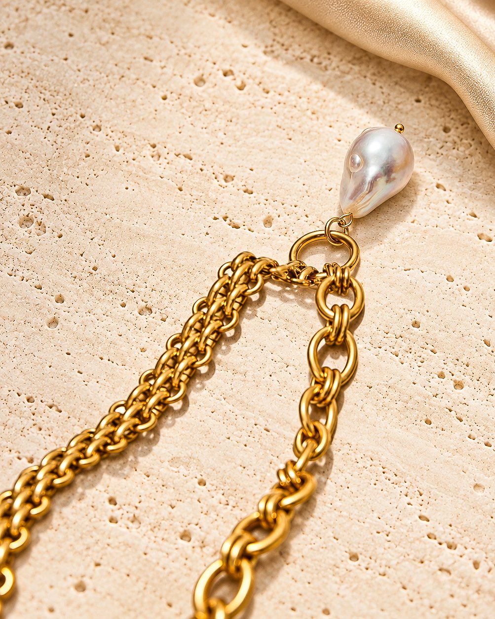 Valeria Necklace detail shot showing interlinked chain, open rings, and pearl-inspired pendant