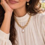 Valeria Necklace worn by model with mixed chain design and pearl-inspired pendant