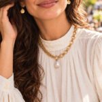 Close-up of Valeria Necklace on model showing open rings and pearl-inspired pendant