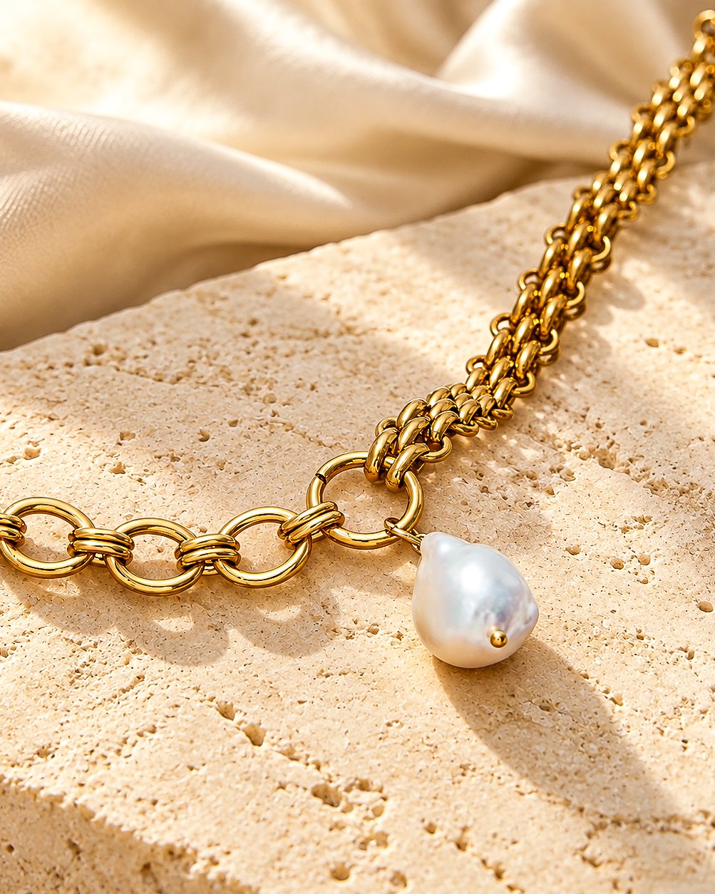 Valeria Necklace on marble background with mixed gold chain and pearl-inspired pendant