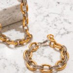 Elegant Regia Trama Collection display on marble background with coordinated necklace and bracelet