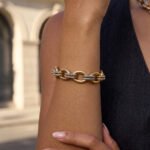 Bracciale Regia Trama bracelet on model showing the gold and silver-toned ring pattern