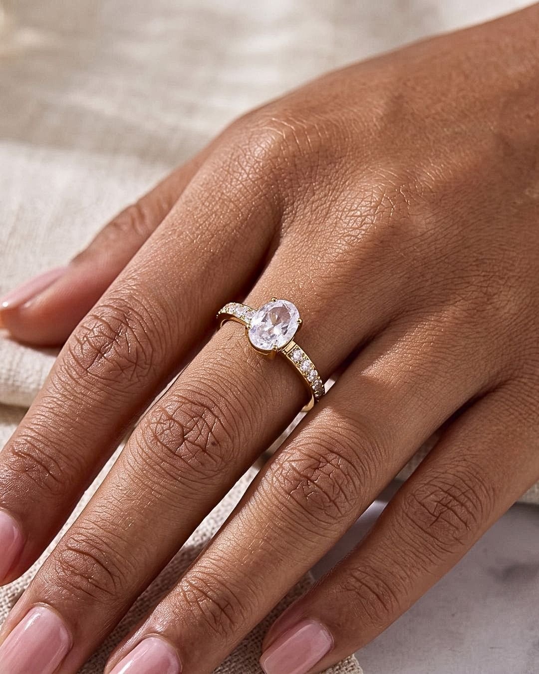 Cristallo Ovale Ring worn close-up on finger with sparkling stones