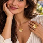 Close-up of Fiore Aurelia Collection on model featuring floral necklace and matching ring