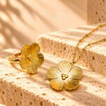 Fiore Aurelia Collection on marble background with floral necklace and matching ring