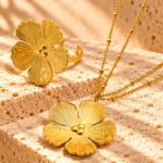 Fiore Aurelia Collection flat lay with floral necklace and matching ring