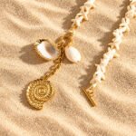 Close-up product image of Marina Alba Necklace charms including shell and spiral pendant details
