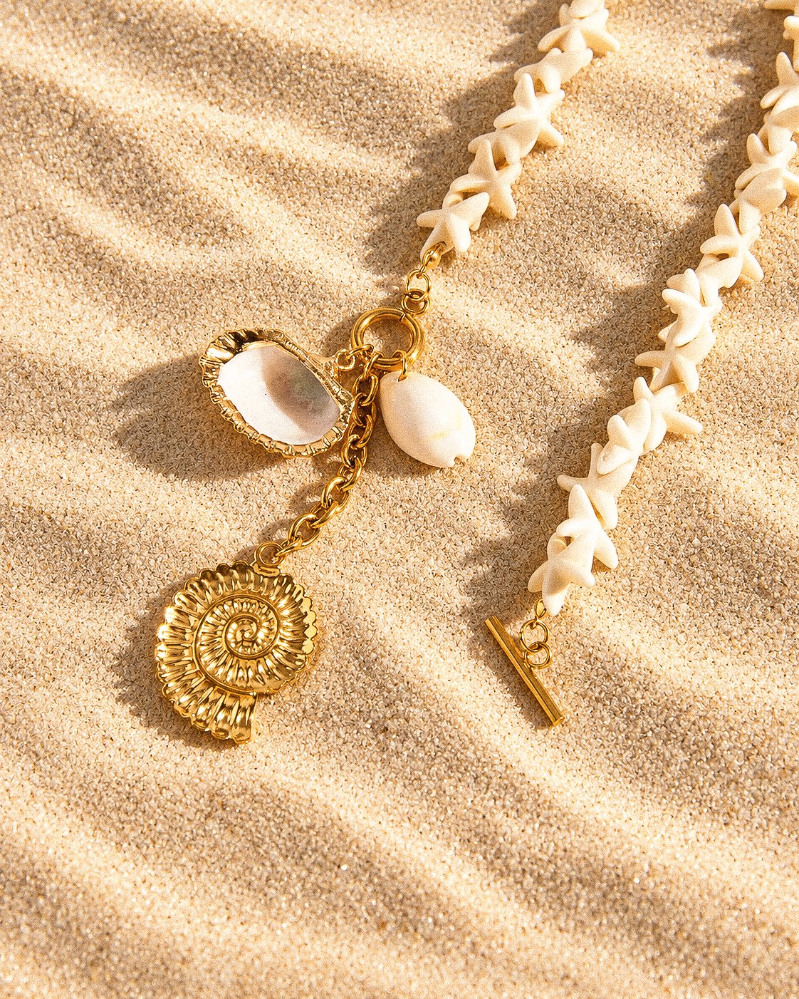 Close-up product image of Marina Alba Necklace charms including shell and spiral pendant details