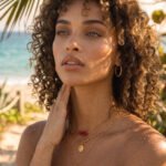 Model wearing Seravelle Necklace in a mid shot with layered gold and coastal-inspired details