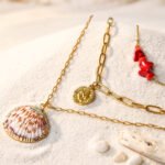 Seravelle Necklace displayed on an elegant background with layered gold chains and coastal-inspired details