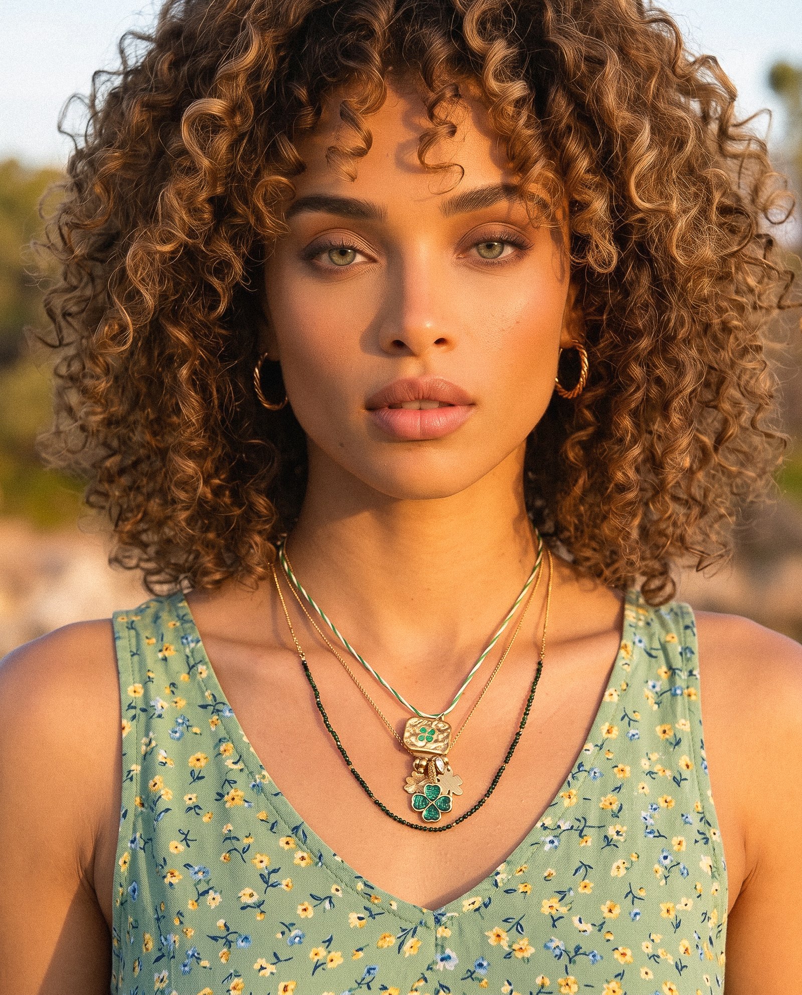 Woman wearing Veralia Duo Necklace with layered green and gold clover details