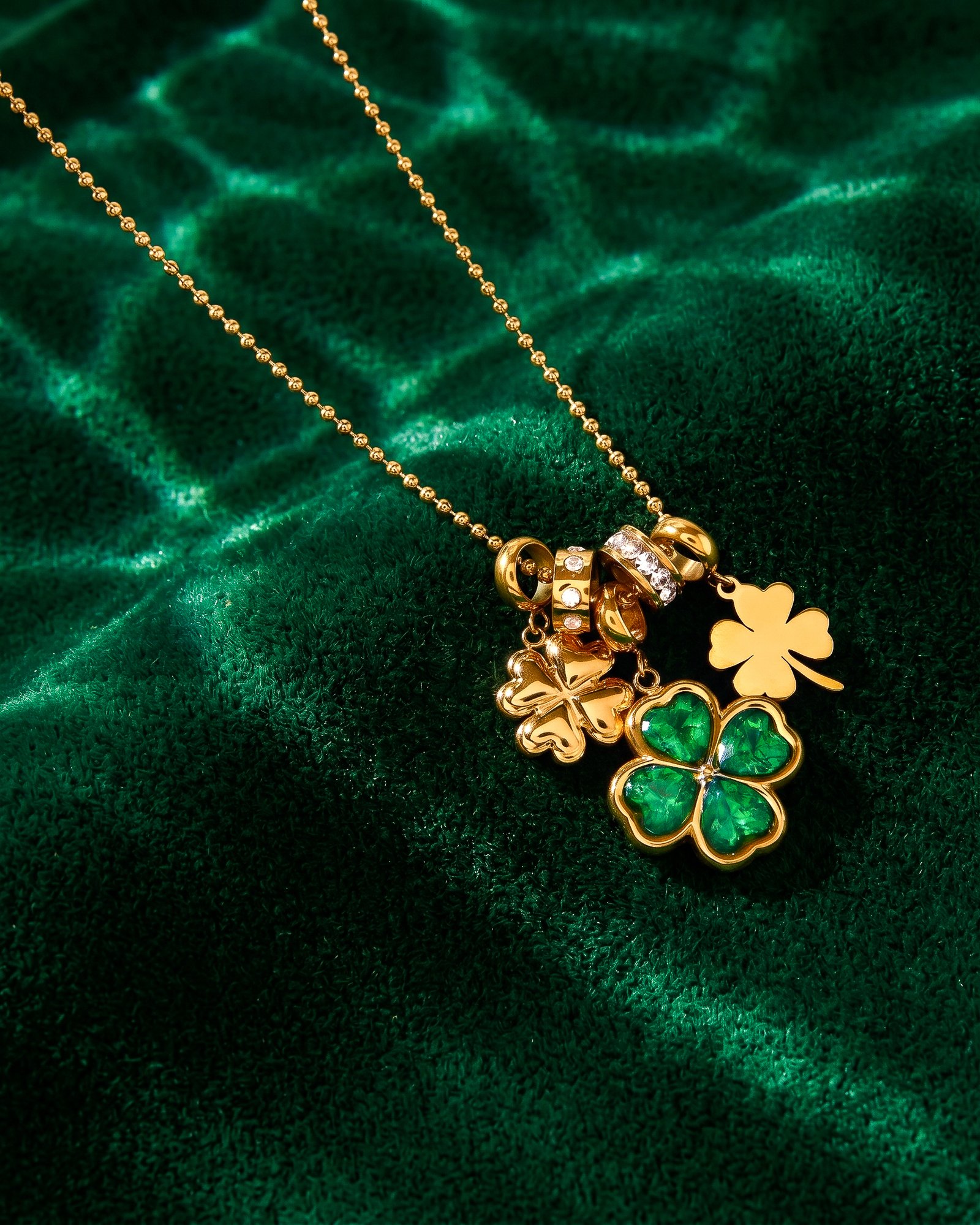 Veralia Duo Necklace displayed on luxury background with green and gold layered clover design