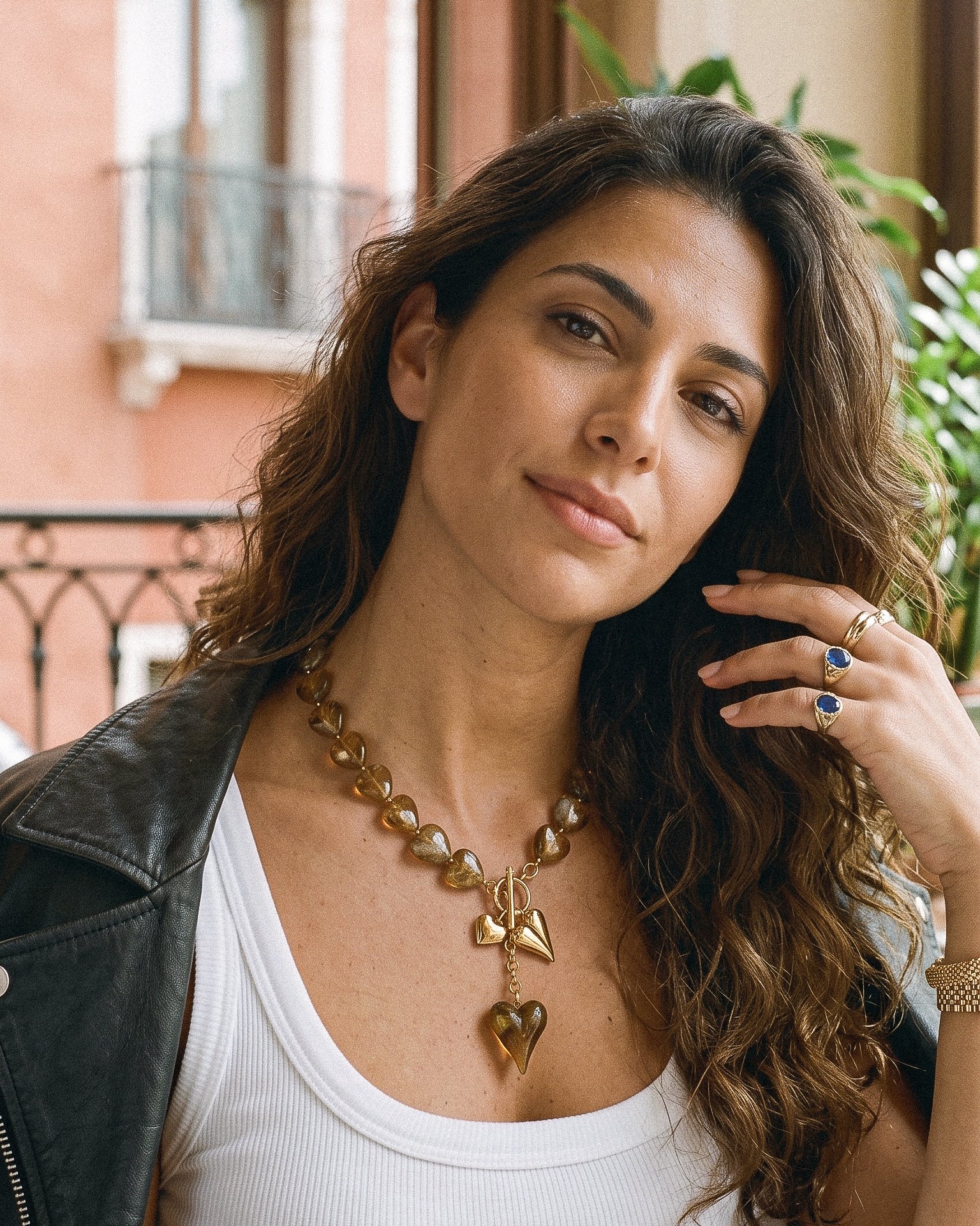 Close-up of Ambralia Necklace on model showing smoky heart beads and toggle detail