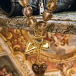 Ambralia Necklace on marble background with smoky heart beads and gold heart details
