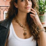 Ambralia Necklace neckline detail on model with dangling heart pendant