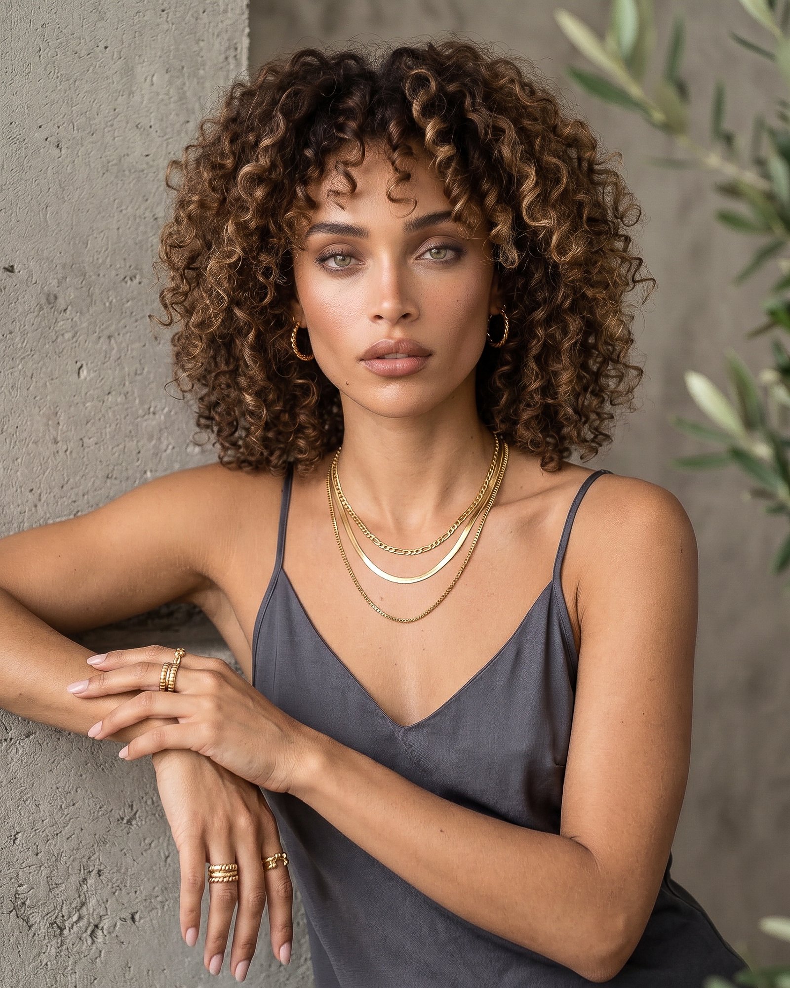 Elvara Necklace on model angled view with layered gold chains