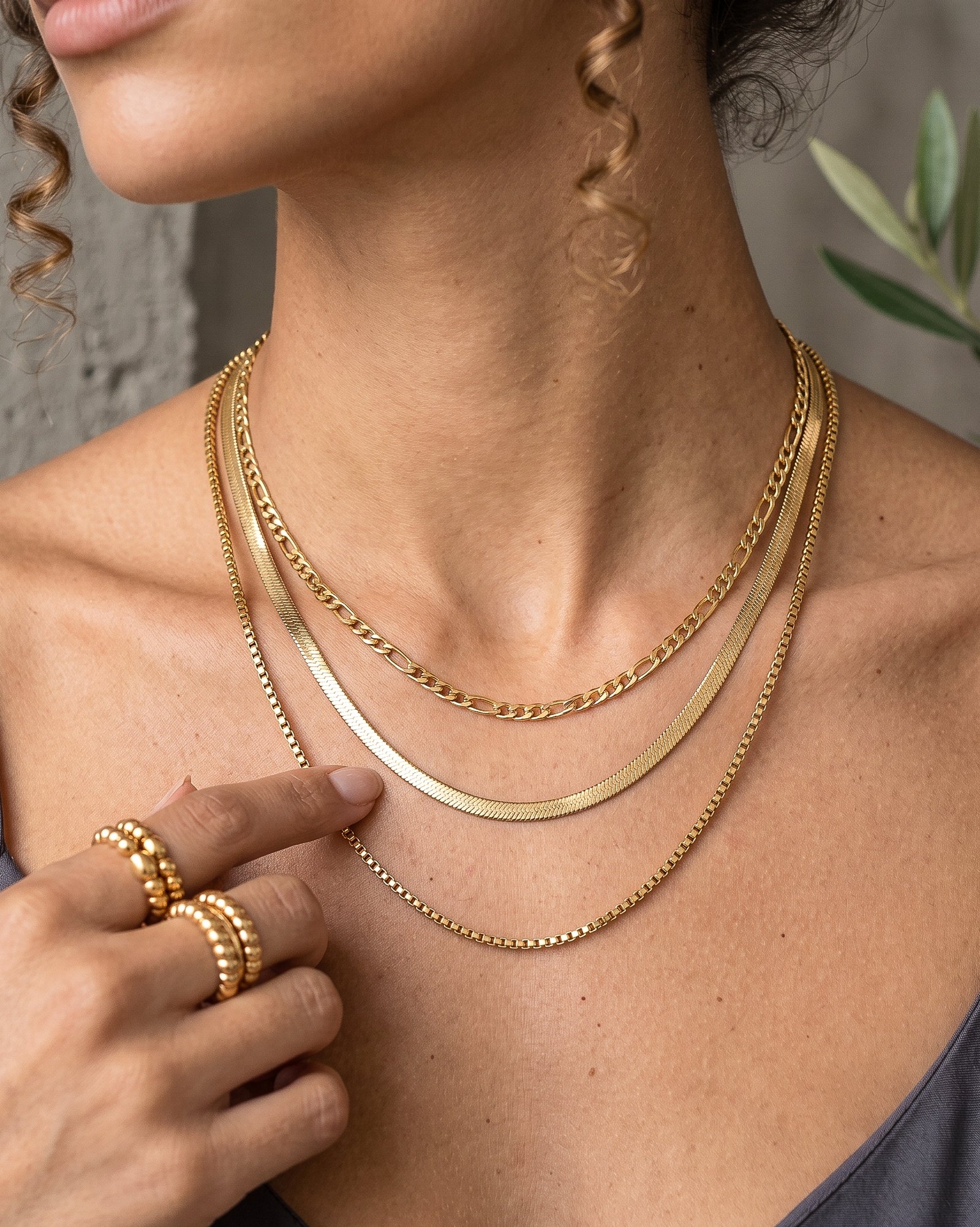 Close-up of Elvara Necklace on model showing layered gold chain details