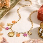 Fiori Solari Necklace displayed on a clean background, featuring a gold paperclip chain with colorful floral charms and a medallion pendant