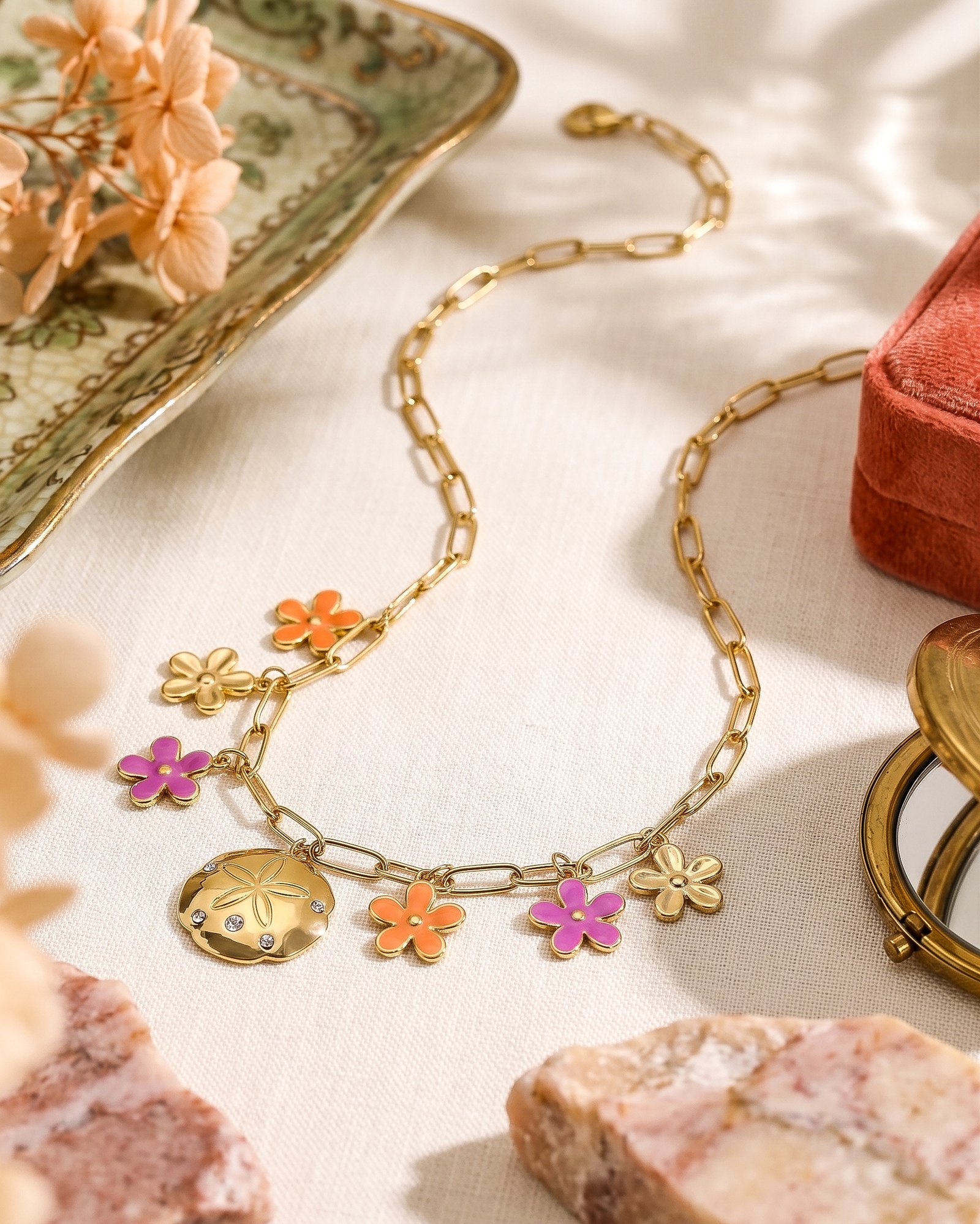 Fiori Solari Necklace displayed on a clean background, featuring a gold paperclip chain with colorful floral charms and a medallion pendant