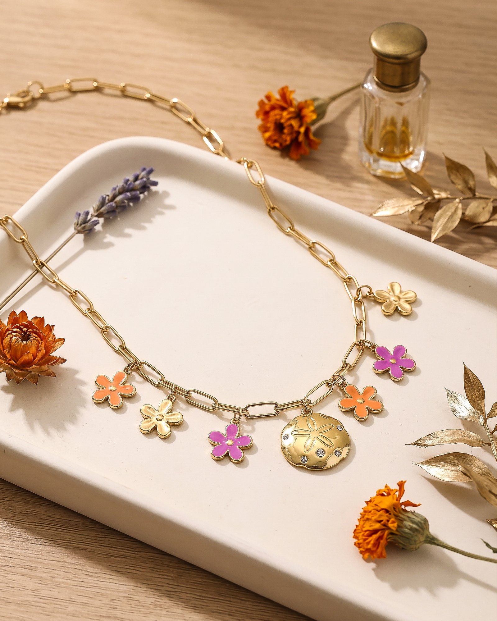Fiori Solari Necklace displayed on a neutral background, featuring a gold plated paperclip chain and colorful flower charms