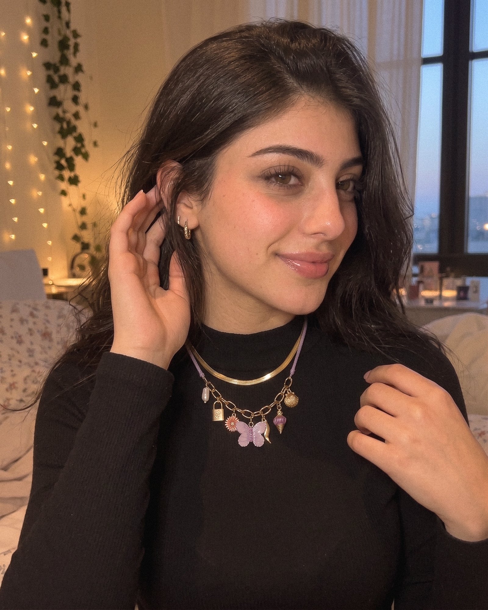 Side-angle model photo of Lunella Charm Necklace with lilac cord and gold chain section