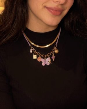 Close-up of Lunella Charm Necklace on model showing butterfly and charm details