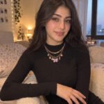 Lunella Charm Necklace styled on model with a soft feminine outfit