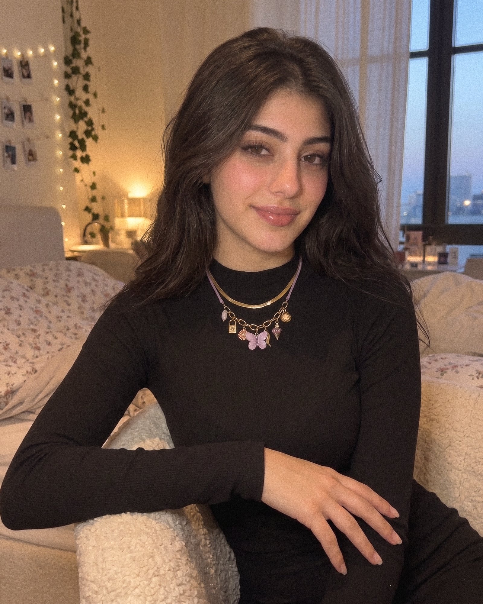 Lunella Charm Necklace styled on model with a soft feminine outfit